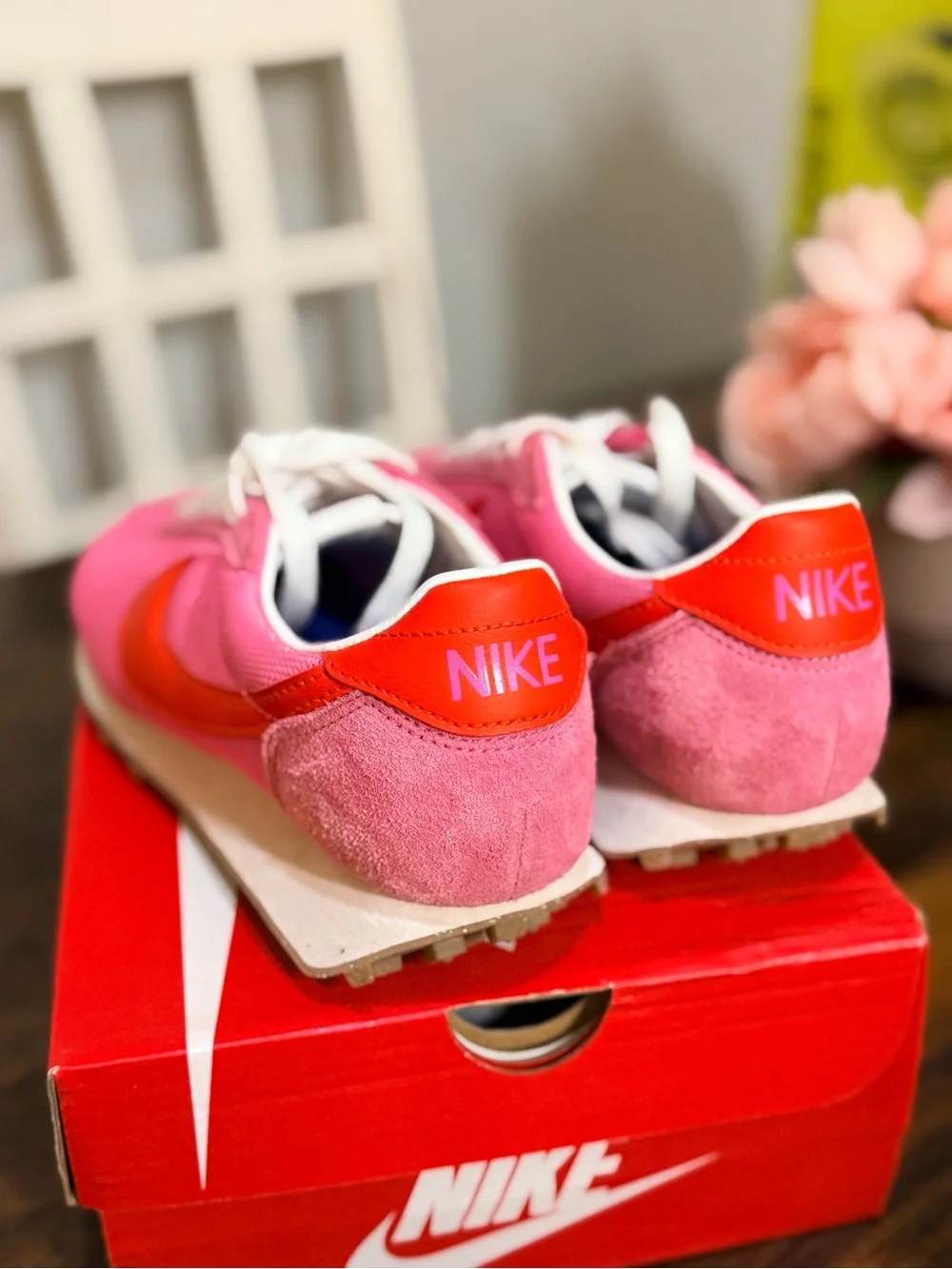 Nike Women's Pink Sneakers with Orange Swoosh